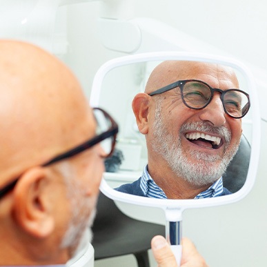 A man smiling in a mirror